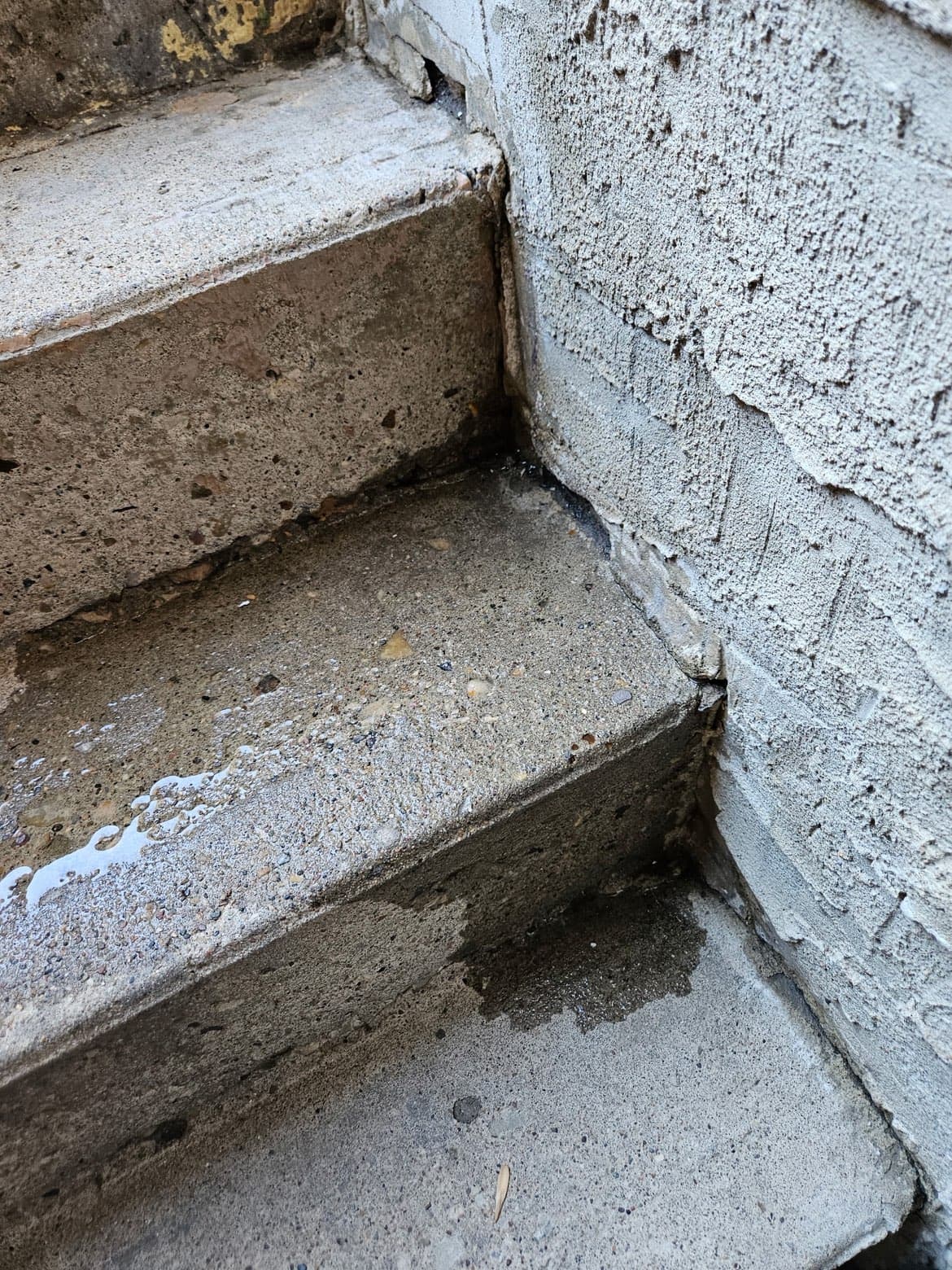 Water seepage at exterior steps before restoration