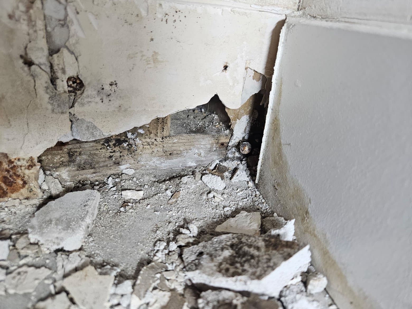 Structural damage at wall corner before restoration